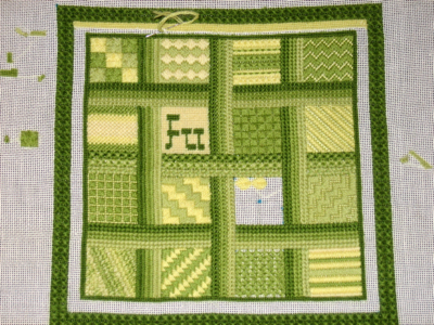 green and yellow squares of needlepoint sampler