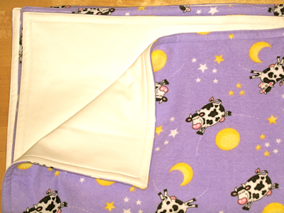 cows jumping over the moon on purple blanket