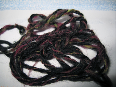 black, purple and green yarn